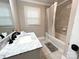 Bright bathroom featuring a marble countertop vanity and shower-tub combination with tile surround at 508 Deese St, Monroe, NC 28112