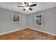 Comfortable bedroom with hardwood floors and natural light from two large windows at 508 Deese St, Monroe, NC 28112