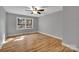 Bright bedroom with hardwood floors and a large window overlooking the yard at 508 Deese St, Monroe, NC 28112
