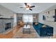 Bright living room featuring a decorative fireplace, hardwood floors, and stylish furniture at 508 Deese St, Monroe, NC 28112