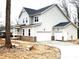 Two-story house with gray siding, brick accents, and a two-car garage at 557 W Lowrance Ave, Mooresville, NC 28115