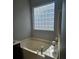 Bathroom with a soaking tub and glass block window at 13123 Ashley Meadow Dr, Charlotte, NC 28213