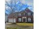 Brick two-story house with a three-car garage and landscaped lawn at 13123 Ashley Meadow Dr, Charlotte, NC 28213