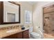 Bathroom with granite vanity, shower, and window at 18528 Nantz Rd, Cornelius, NC 28031