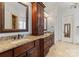 Double vanity bathroom with granite countertops and tall storage at 18528 Nantz Rd, Cornelius, NC 28031