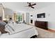 Main bedroom with king-size bed, TV, and access to balcony at 18528 Nantz Rd, Cornelius, NC 28031