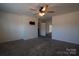 Grey carpeted bedroom with ceiling fan and access to other rooms at 1924 Lakeview Dr, Rock Hill, SC 29732