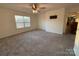 Large bedroom with grey carpet, ceiling fan and access to other rooms at 1924 Lakeview Dr, Rock Hill, SC 29732