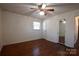 Hardwood floor bedroom with ceiling fan and mirrored closet at 1924 Lakeview Dr, Rock Hill, SC 29732