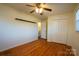 Bright bedroom with hardwood floors, ceiling fan, and double door closet at 1924 Lakeview Dr, Rock Hill, SC 29732