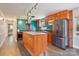 Modern kitchen with teal tile backsplash, wood cabinets, and island at 1924 Lakeview Dr, Rock Hill, SC 29732