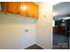 Laundry area with overhead cabinets and a view into the kitchen at 1924 Lakeview Dr, Rock Hill, SC 29732