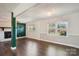 Open living area with hardwood floors, large windows, and a decorative accent wall at 1924 Lakeview Dr, Rock Hill, SC 29732