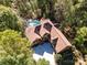 An aerial view of the lovely home, showing the front entrance, driveway and tree-lined property at 7029 Pebble Bay Dr, Denver, NC 28037