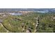 An aerial view of a wooded neighborhood with lakes in the distance at 7029 Pebble Bay Dr, Denver, NC 28037