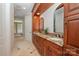 Bathroom with double sinks, granite countertops, and tiled backsplash at 7029 Pebble Bay Dr, Denver, NC 28037