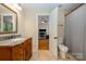 Bathroom featuring granite countertop vanity and shower with curtain, adjacent to office at 7029 Pebble Bay Dr, Denver, NC 28037