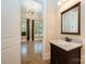 Bathroom featuring granite countertop, dark wood vanity, and a view to the bedroom at 7029 Pebble Bay Dr, Denver, NC 28037