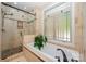 Bathroom features tiled shower, tub, and a large window for natural light at 7029 Pebble Bay Dr, Denver, NC 28037