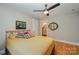 Bedroom with gold metal bed frame, ceiling fan and view to ensuite bathroom at 7029 Pebble Bay Dr, Denver, NC 28037