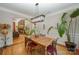 An elegant dining room with hardwood floors, a wooden table and chairs, and an open view into a cozy living room at 7029 Pebble Bay Dr, Denver, NC 28037