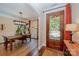 Inviting entryway featuring a decorative glass front door, hardwood floors, and an adjacent dining area with a wooden table at 7029 Pebble Bay Dr, Denver, NC 28037