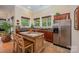 Kitchen area features a kitchen island with seating, stainless steel refrigerator and decorative backsplash at 7029 Pebble Bay Dr, Denver, NC 28037