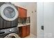 Laundry room boasts washer and dryer and overhead cabinetry and granite countertop at 7029 Pebble Bay Dr, Denver, NC 28037