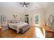 Bright bedroom featuring wood floors, ceiling fan, and access to a private balcony at 7029 Pebble Bay Dr, Denver, NC 28037