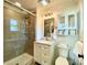 Modern bathroom with a glass-enclosed shower, vanity storage, and decorative cabinet shelves, showcasing contemporary design at 796 Cornelius Rd, Mooresville, NC 28117