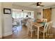 Open-concept dining area featuring a barn door and views into the living room at 796 Cornelius Rd, Mooresville, NC 28117