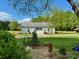 Charming white barn building surrounded by greenery on a sunny day, with a stone pathway at 796 Cornelius Rd, Mooresville, NC 28117