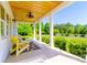 Covered front porch featuring a wood plank ceiling, pendant lights, and yellow chairs with outdoor rug at 796 Cornelius Rd, Mooresville, NC 28117