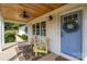 Inviting front porch with chairs, a wreath, and white brick at 796 Cornelius Rd, Mooresville, NC 28117