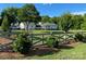 Charming single-story home with a long driveway, beautiful lawn, and decorative wooden fence at 796 Cornelius Rd, Mooresville, NC 28117