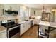 Modern kitchen with stainless steel appliances, granite countertops, and white cabinets at 796 Cornelius Rd, Mooresville, NC 28117