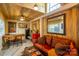 Rustic living room featuring wood paneling, a leather sofa, and unique decor creating a cozy atmosphere at 796 Cornelius Rd, Mooresville, NC 28117