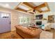 Stylish living room with a brick fireplace, wooden beam ceiling, and hardwood floors at 796 Cornelius Rd, Mooresville, NC 28117