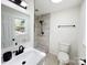 Updated bathroom with black matte fixtures, glass shower door, and bright natural light at 809 23Rd E St, Newton, NC 28658