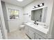 Bright bathroom featuring a modern vanity, updated shower, and window for natural light at 809 23Rd E St, Newton, NC 28658