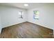 This room is a bedroom with hardwood floors and two windows at 809 23Rd E St, Newton, NC 28658