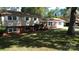 Well-kept exterior featuring a manicured lawn, large shade tree, and freshly painted driveway at 809 23Rd E St, Newton, NC 28658