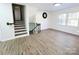 Spacious living room with hardwood floors, staircase and natural light from large windows at 809 23Rd E St, Newton, NC 28658