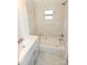 Modern bathroom with marble tile, new vanity, and bright natural light from the window above the tub at 125 S Ervin Ave, Newton, NC 28658