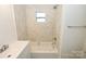 Bright, updated bathroom with shower/tub combo, new toilet, modern vanity, and marble tiled walls at 125 S Ervin Ave, Newton, NC 28658