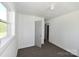 Simple bedroom features neutral carpet, a classic light, and ample sunlight at 125 S Ervin Ave, Newton, NC 28658