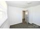 Bright bedroom with a neutral carpet, and one window at 125 S Ervin Ave, Newton, NC 28658