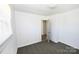 Bright bedroom with neutral carpet, crisp white walls and trim, plus window at 125 S Ervin Ave, Newton, NC 28658