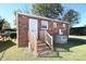 Cozy brick home featuring an outdoor entrance, a small backyard, and central air conditioning at 125 S Ervin Ave, Newton, NC 28658
