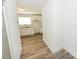 Hallway view leading into a newly renovated kitchen with white cabinets and granite countertops at 125 S Ervin Ave, Newton, NC 28658